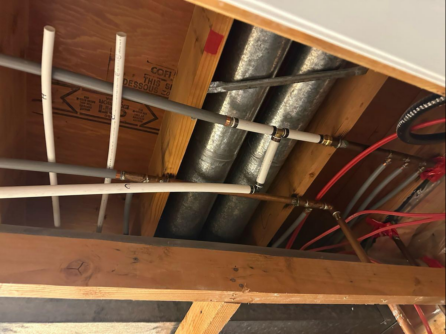 Fresh new plumbing pipes inside of a ceiling