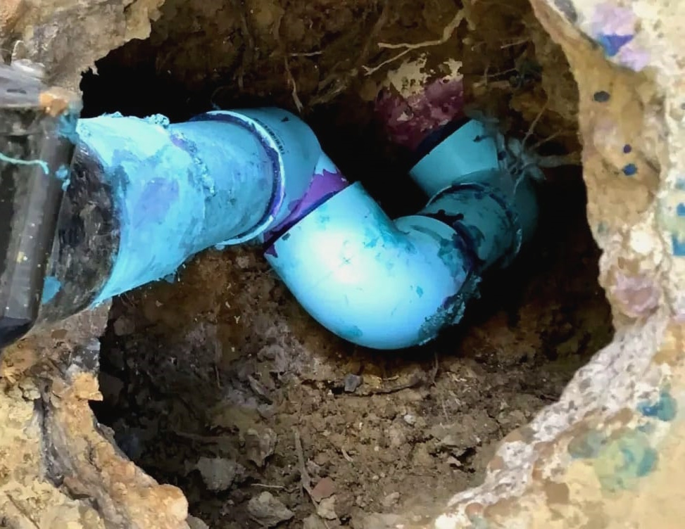 Picture of a blue plastic pipe in the ground